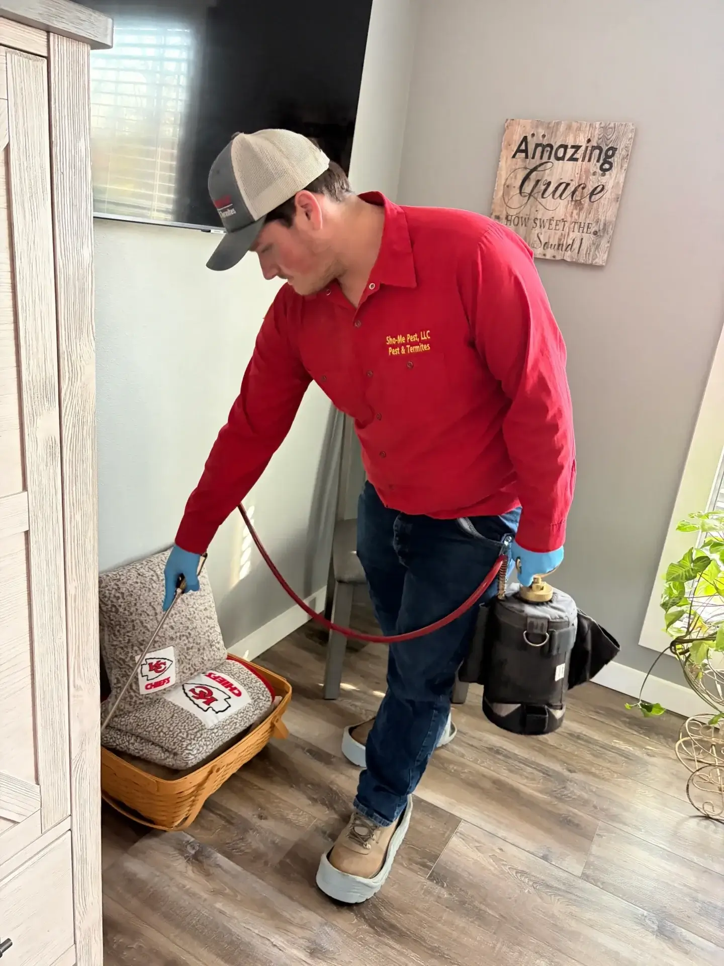 Person spraying insecticide on carpeted stairs.